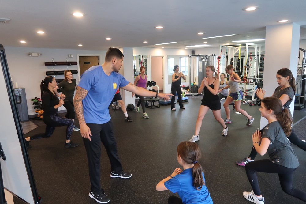 Circuit training class rotating through strength and cardio stations at One2One Fitness